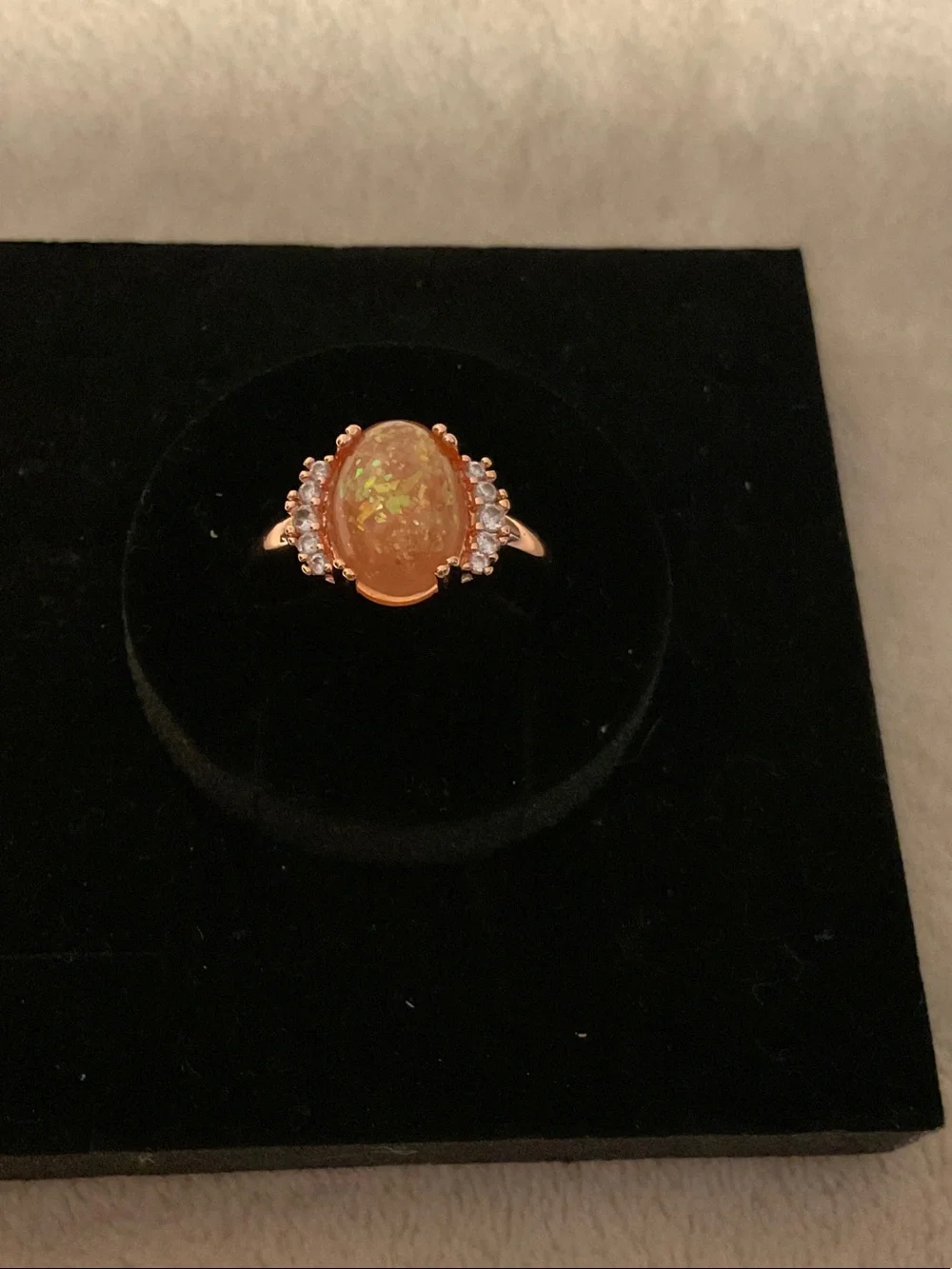 Gold-Tone Ring with Orange Opal Center and Clear Accent Stones